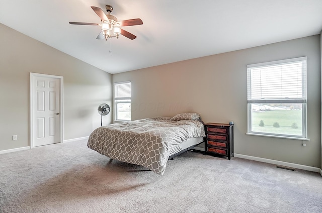 bedroom featuring ceiling fan, light colored carpet, and vaulted ceiling