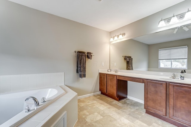 bathroom with vanity and tiled bath