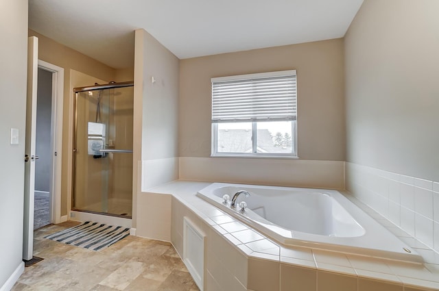 bathroom featuring shower with separate bathtub