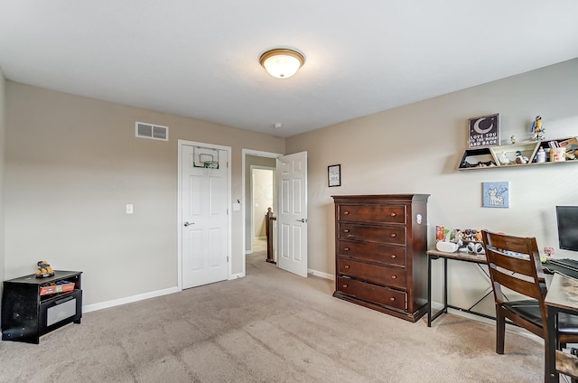 office area featuring light carpet