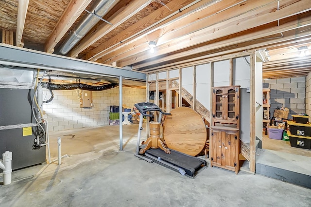 basement with electric panel and heating unit