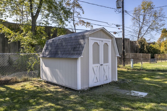 view of outbuilding with a lawn