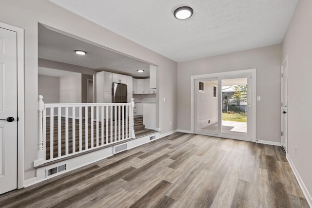 interior space featuring a textured ceiling and light wood-type flooring