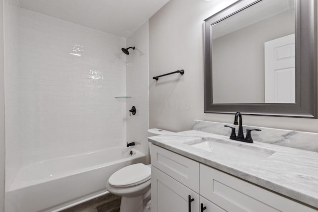 full bathroom featuring vanity, tiled shower / bath combo, toilet, a textured ceiling, and wood-type flooring