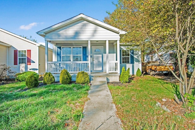 bungalow-style house with covered porch and a front yard