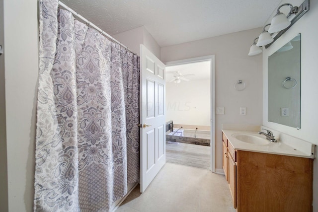 bathroom featuring a textured ceiling, vanity, and ceiling fan