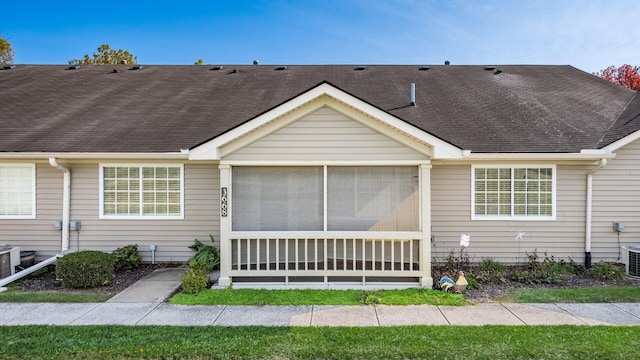 view of front facade with a sunroom and central AC