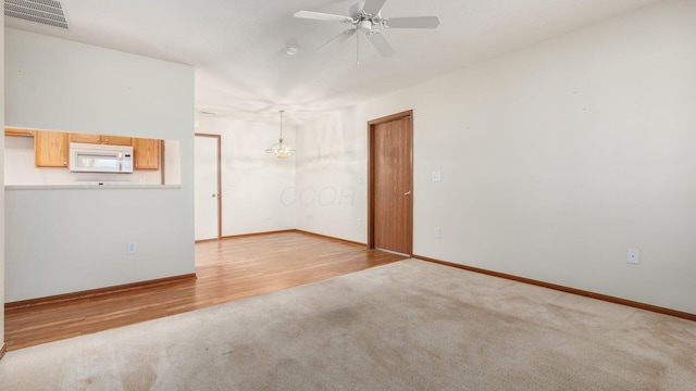 empty room with hardwood / wood-style flooring and ceiling fan