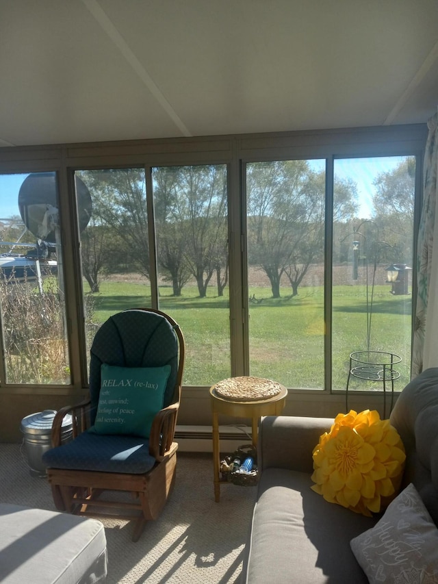 sunroom with a wealth of natural light and a baseboard radiator