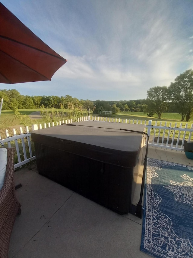 view of patio / terrace with a hot tub