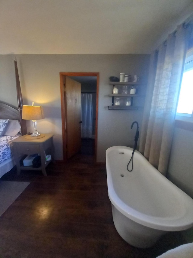 bathroom featuring a tub to relax in and hardwood / wood-style floors