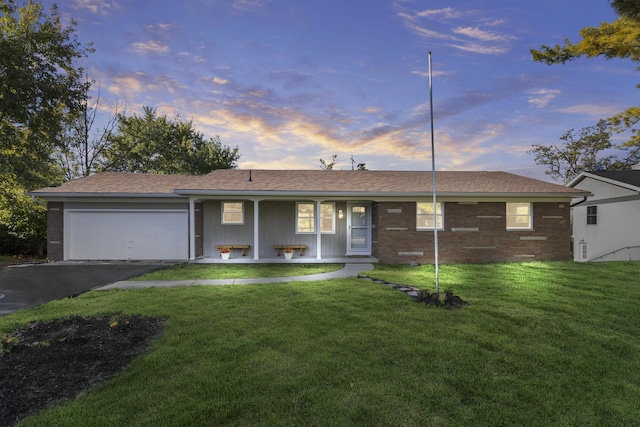 5608 Cardinal Dr, Orient, OH 43146 - ranch-style house featuring a garage, a front lawn, driveway, a porch, and brick siding