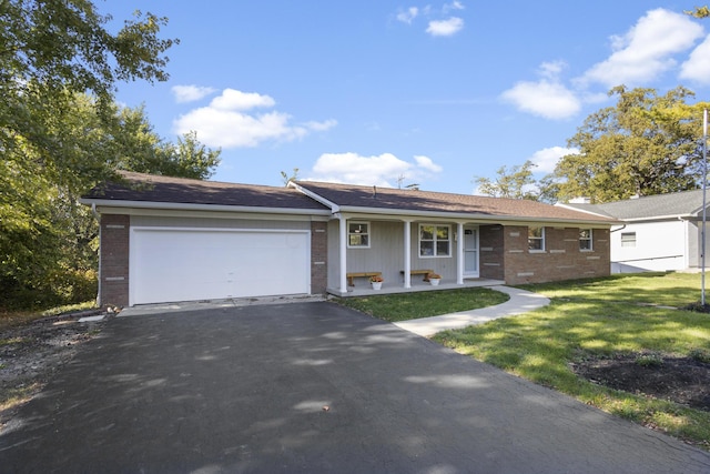 5608 Cardinal Dr, Orient, OH 43146 - single story home with brick siding, driveway, a garage, and covered porch