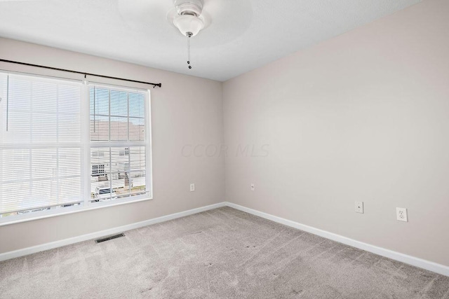 unfurnished room featuring ceiling fan and light colored carpet