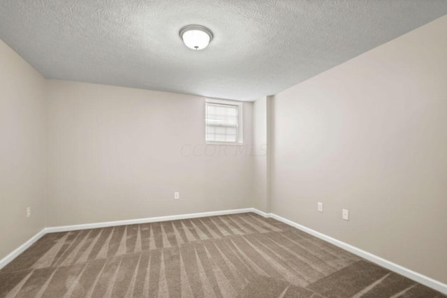 unfurnished room featuring carpet flooring and a textured ceiling