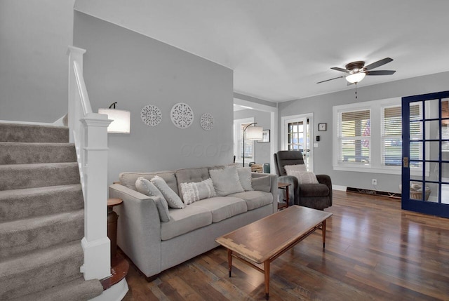 living room featuring ceiling fan and dark hardwood / wood-style flooring