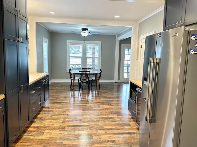 kitchen featuring ceiling fan, high end fridge, crown molding, and light hardwood / wood-style flooring