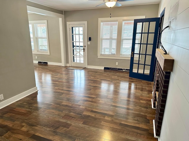 interior space featuring ceiling fan, dark hardwood / wood-style floors, and a baseboard heating unit