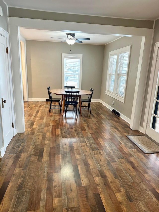 dining room featuring ceiling fan and dark wood-type flooring