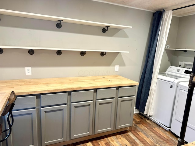 clothes washing area featuring dark hardwood / wood-style floors and washing machine and dryer