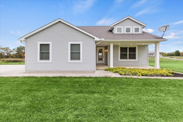 view of front of property featuring covered porch and a front yard