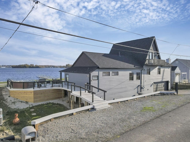 dock area featuring a deck with water view and a balcony