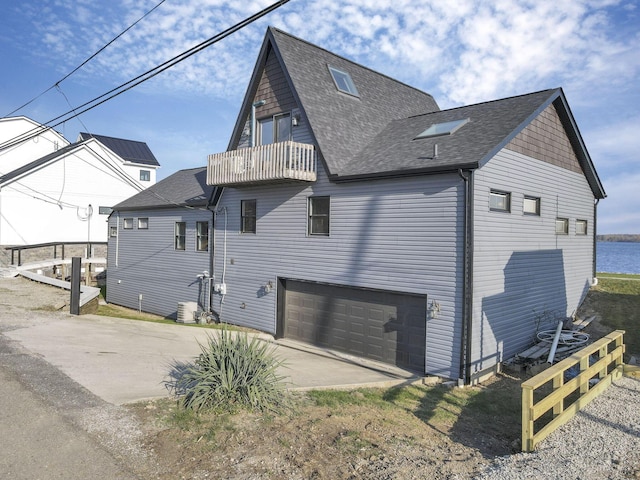 exterior space featuring a balcony and a garage