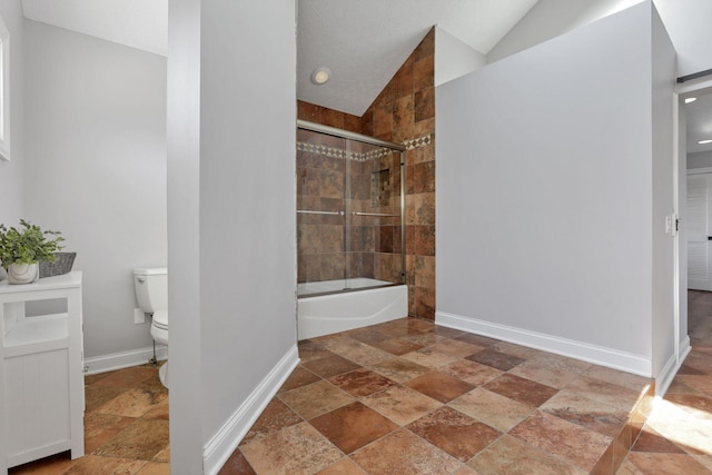 bathroom featuring combined bath / shower with glass door, toilet, and lofted ceiling