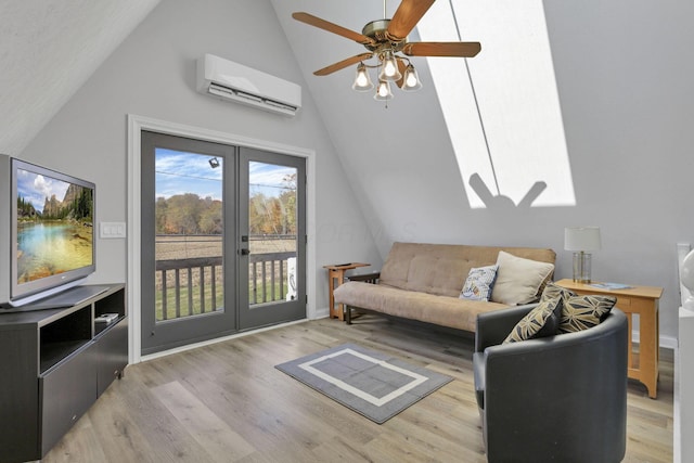 living room with lofted ceiling, french doors, light hardwood / wood-style flooring, ceiling fan, and a wall mounted AC