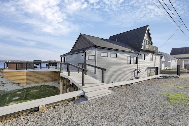 view of home's exterior with a balcony and a deck