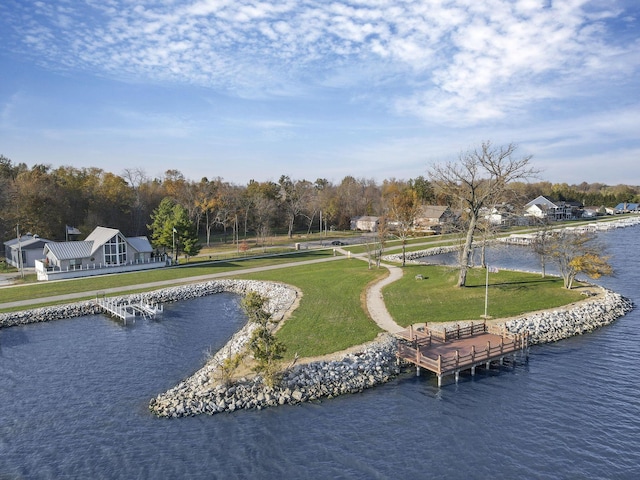 view of property's community featuring a yard and a water view