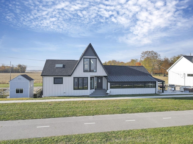 modern inspired farmhouse featuring a shed and a front yard