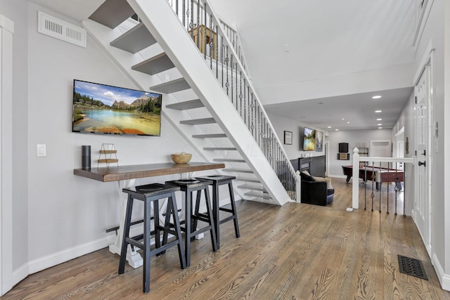 stairs with hardwood / wood-style flooring