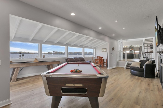 game room featuring lofted ceiling with beams, light wood-type flooring, a textured ceiling, and pool table