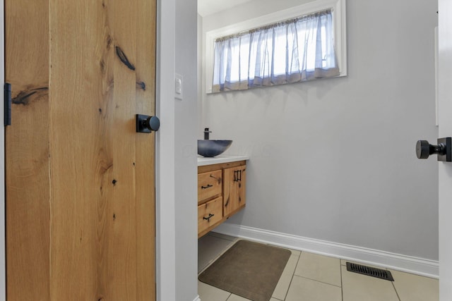 bathroom featuring tile patterned flooring and vanity