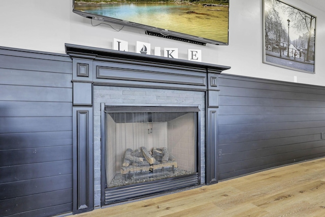 interior details with wood walls and wood-type flooring