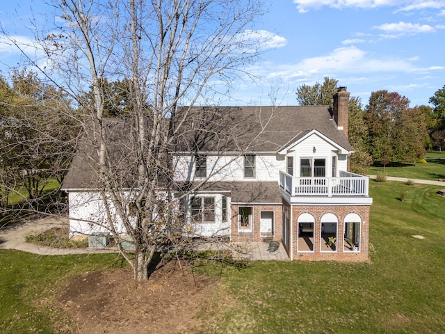 back of property featuring a lawn, a patio area, and a balcony