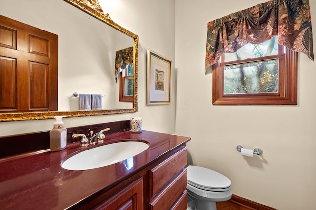 bathroom featuring vanity and toilet