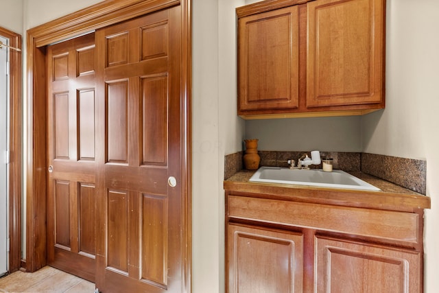 kitchen with light tile patterned floors and sink