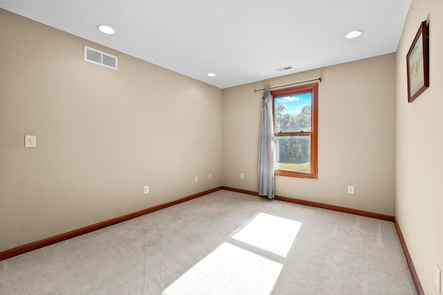 spare room featuring light colored carpet