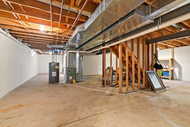 basement featuring heating unit and electric water heater