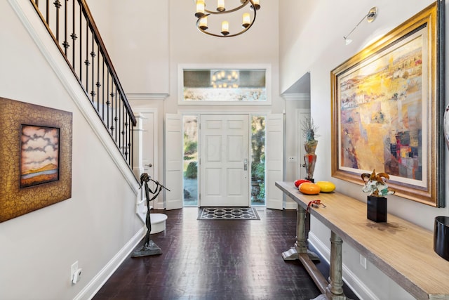 entryway with a high ceiling and a chandelier