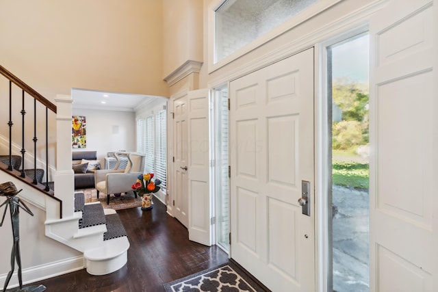 foyer entrance featuring crown molding and dark hardwood / wood-style floors