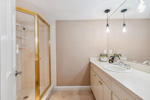 bathroom featuring a shower with door and vanity