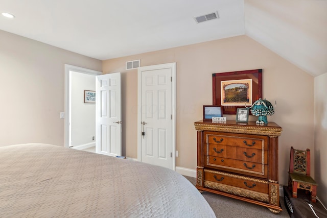 carpeted bedroom with lofted ceiling