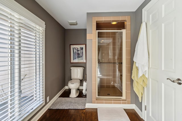 bathroom featuring toilet, hardwood / wood-style floors, and walk in shower