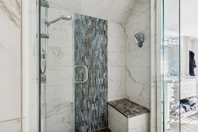 bathroom featuring a shower with shower door