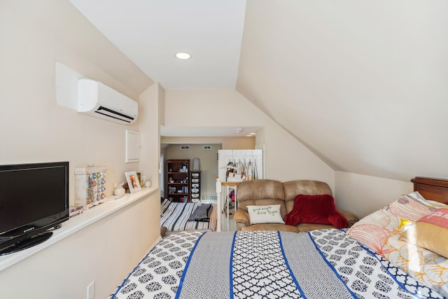 bedroom with a wall mounted AC and vaulted ceiling