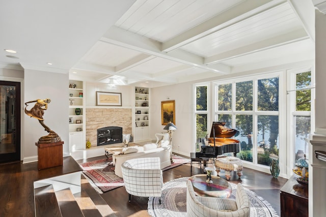 living room with beamed ceiling, a fireplace, dark hardwood / wood-style floors, and built in shelves