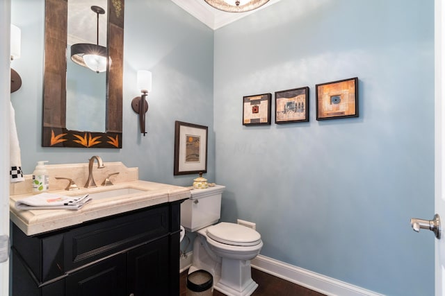 bathroom with hardwood / wood-style floors, toilet, vanity, and ornamental molding